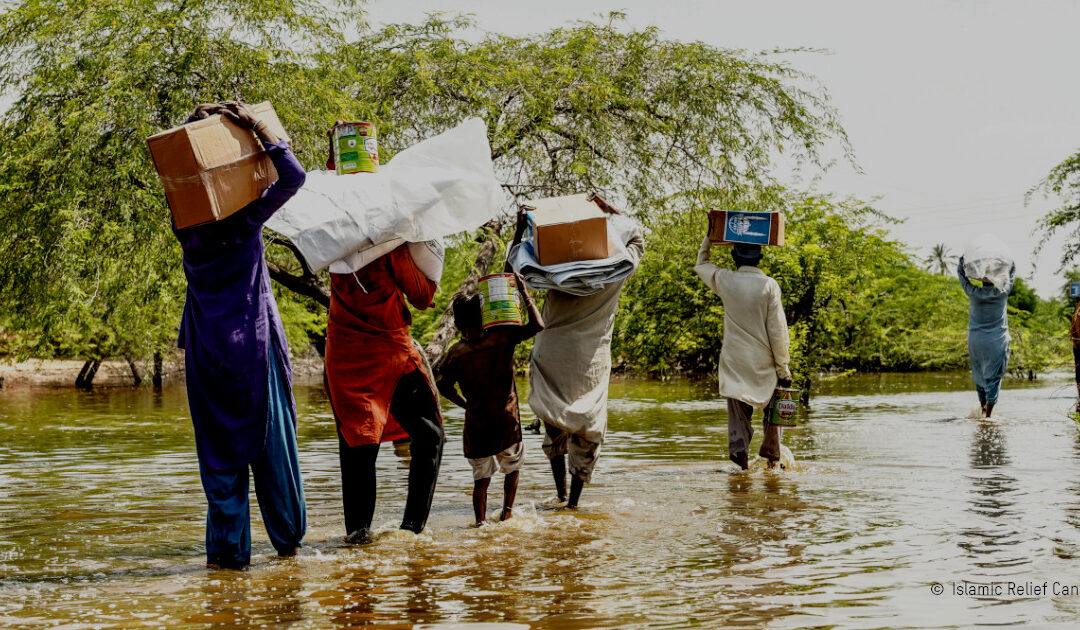 People walk through floodwaters in Pakistan. Photo: Islamic Relief Canada